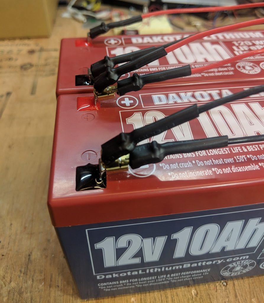 Two 12 volt batteries wired in parallel to increase the total amp hours or capacity